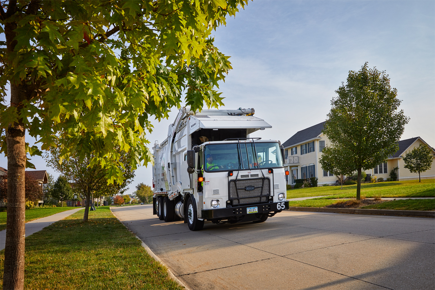 A low-cab-forward Autocar refuse truck works the streets of central Iowa.