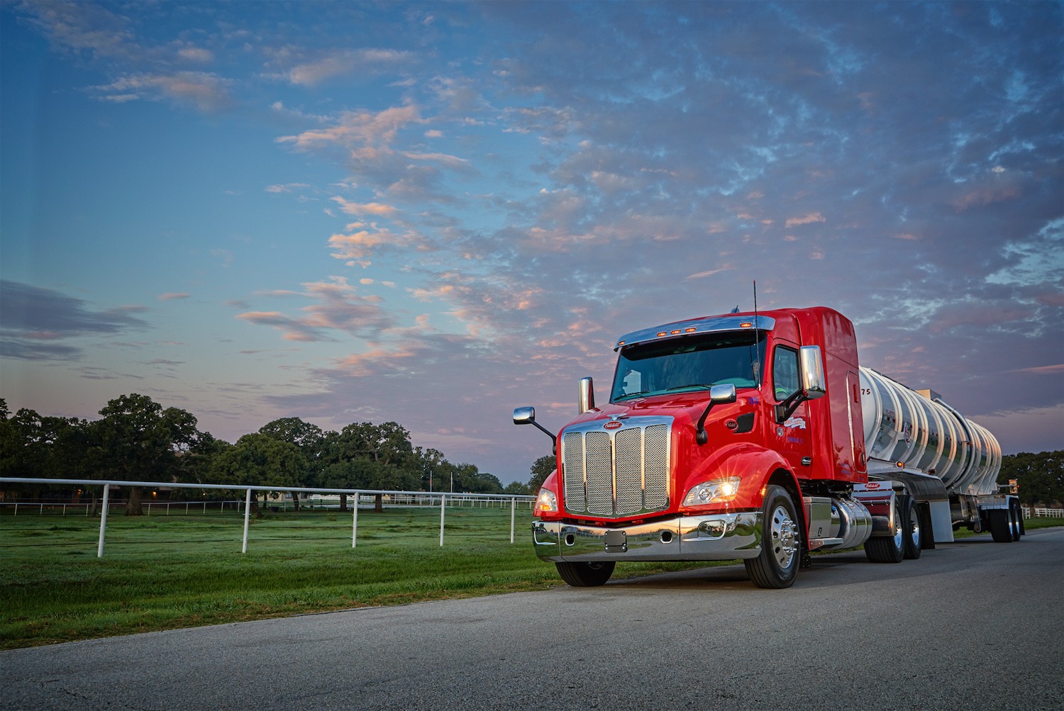 A Peterbilt Model 579 and petroleum trailer stand out on a country road in Texas.