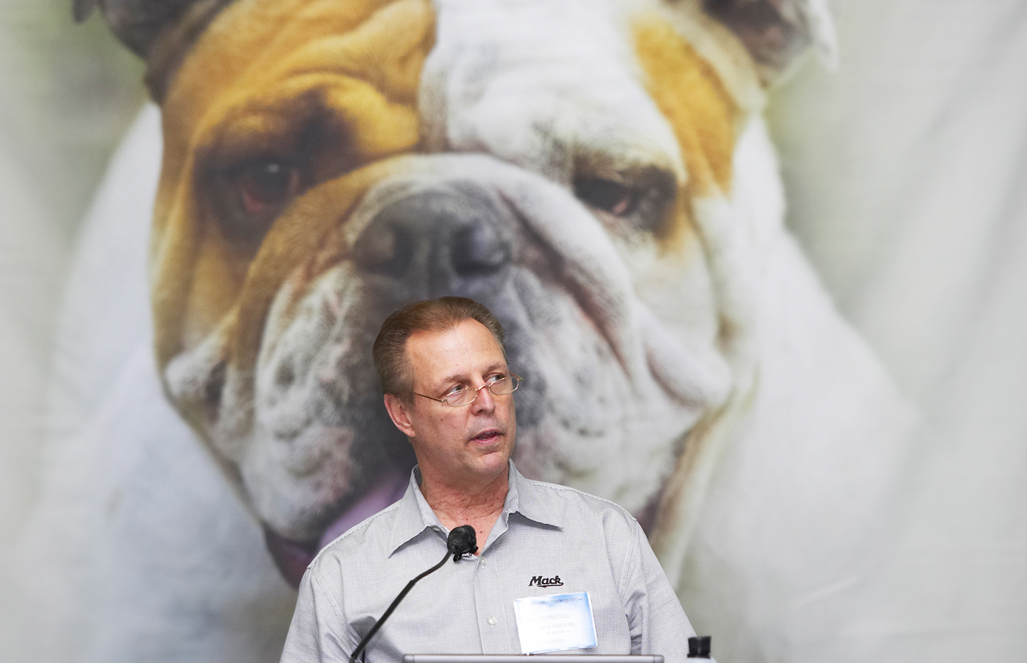 A Mack executive dwarfed by an image of his company's mascot