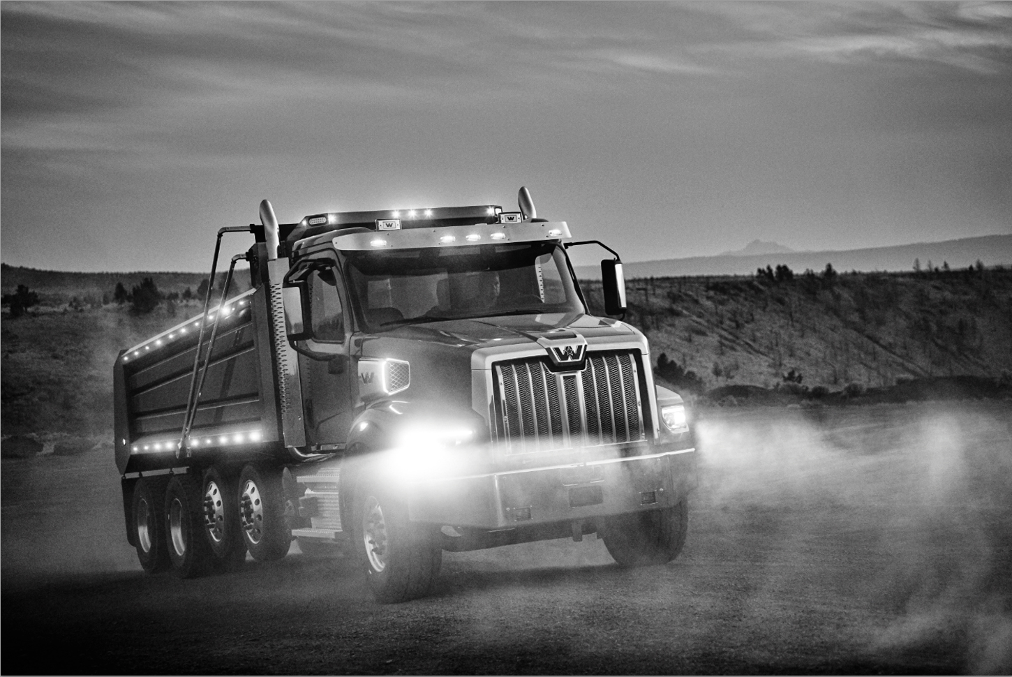 A Western Star 49X illuminating the dust of a country road in Central Oregon