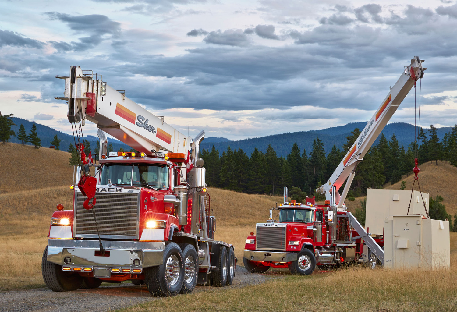 A pair of Mack boom trucks add color to the landscape in British Columbia.