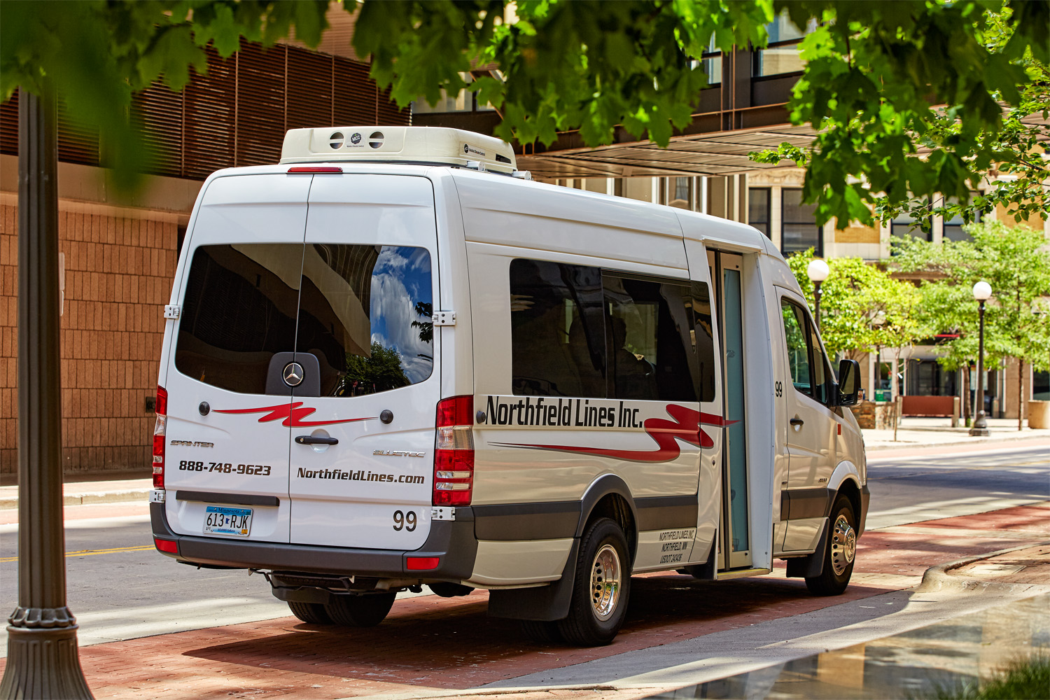 A small transit bus awaits riders on a summer day in St. Paul, Minn.