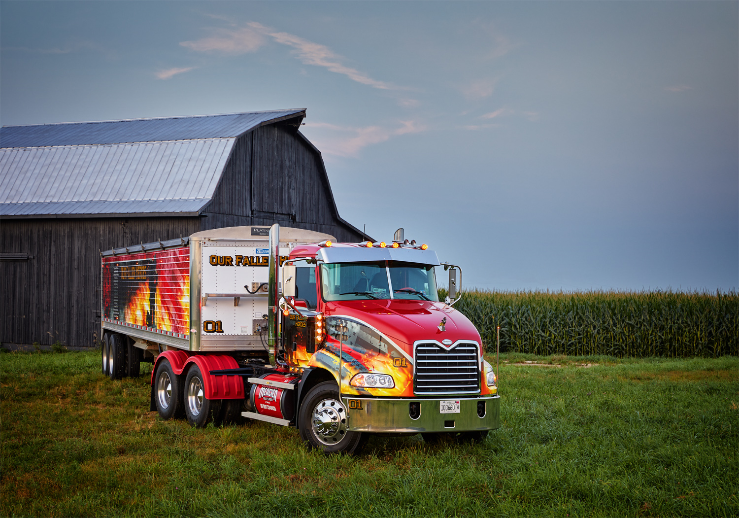 A Mack truck and grain trailer parked on a farm site in Illinois