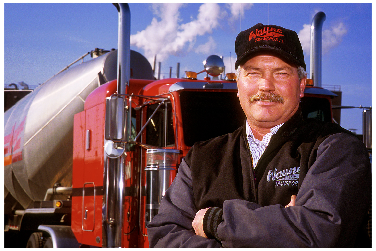 A proud trucker wearing branded company-issued apparel