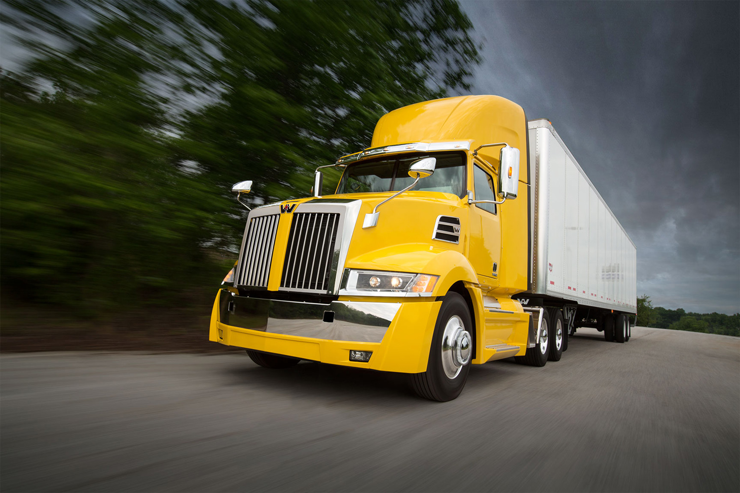 A Western Star 5700XE daycare tractor and dryvan trailer speed down a road in South Carolina.